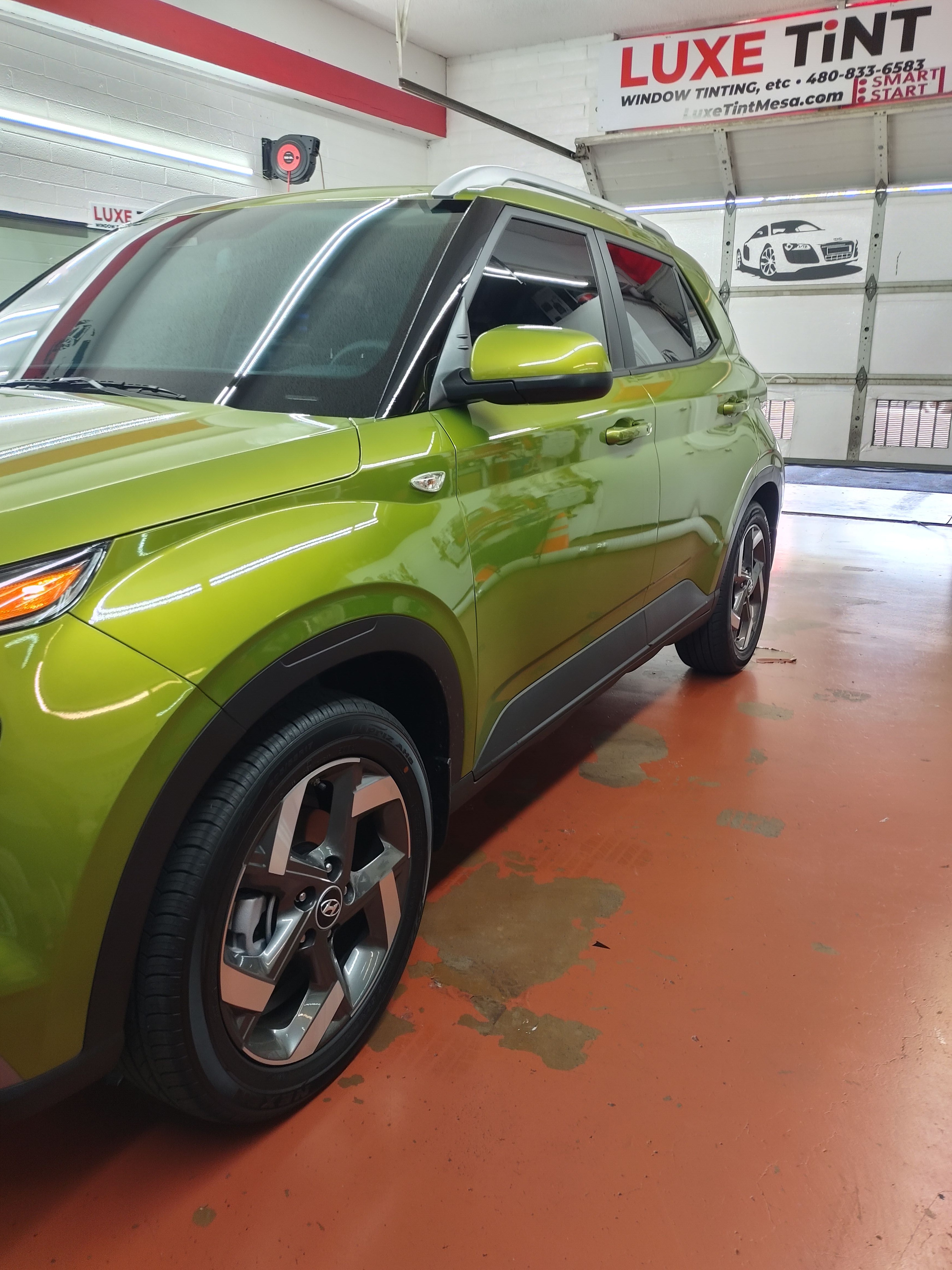 Lime green Hyundai Venue, side