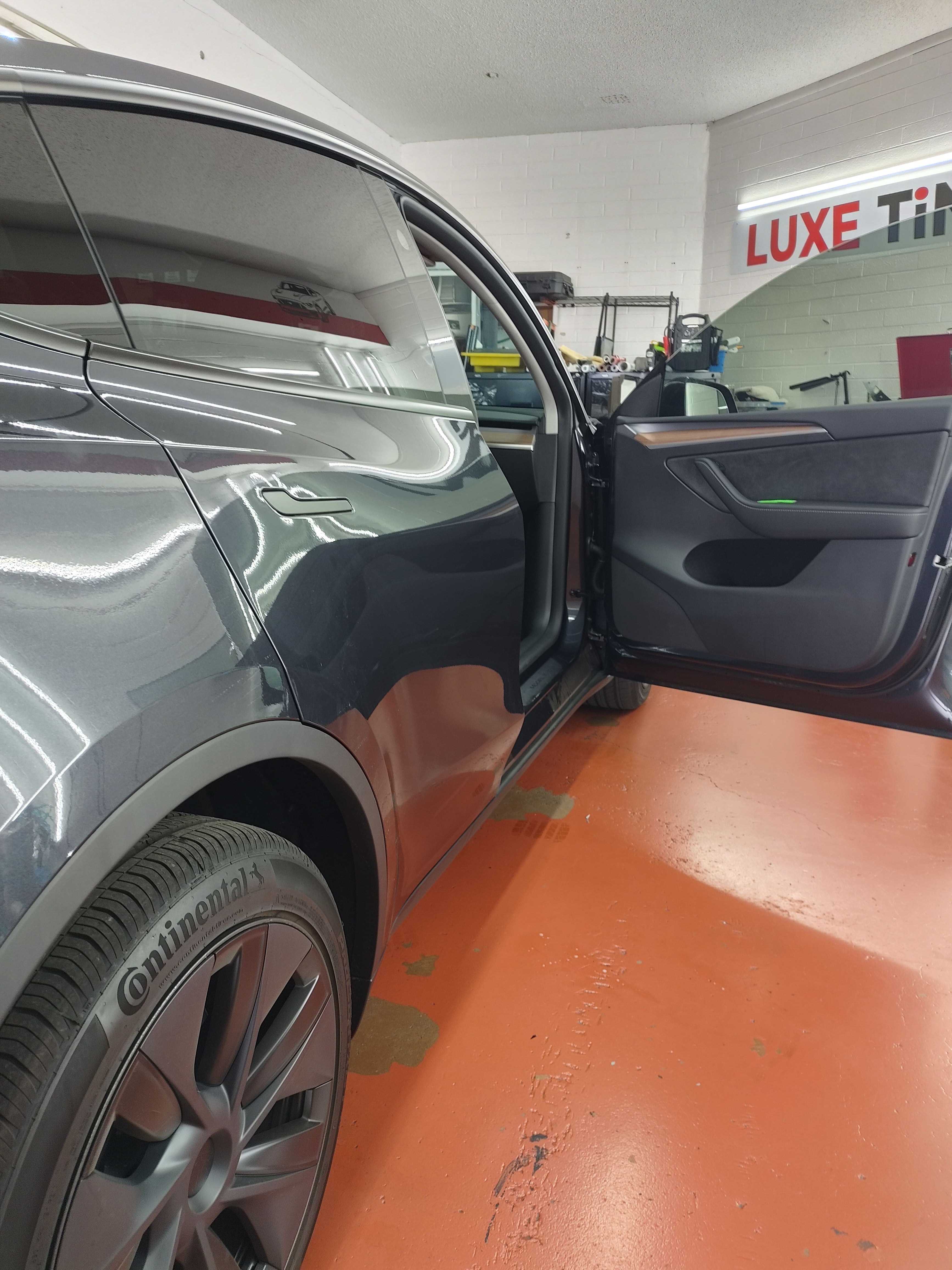 Grey Tesla Model 3, side with door open