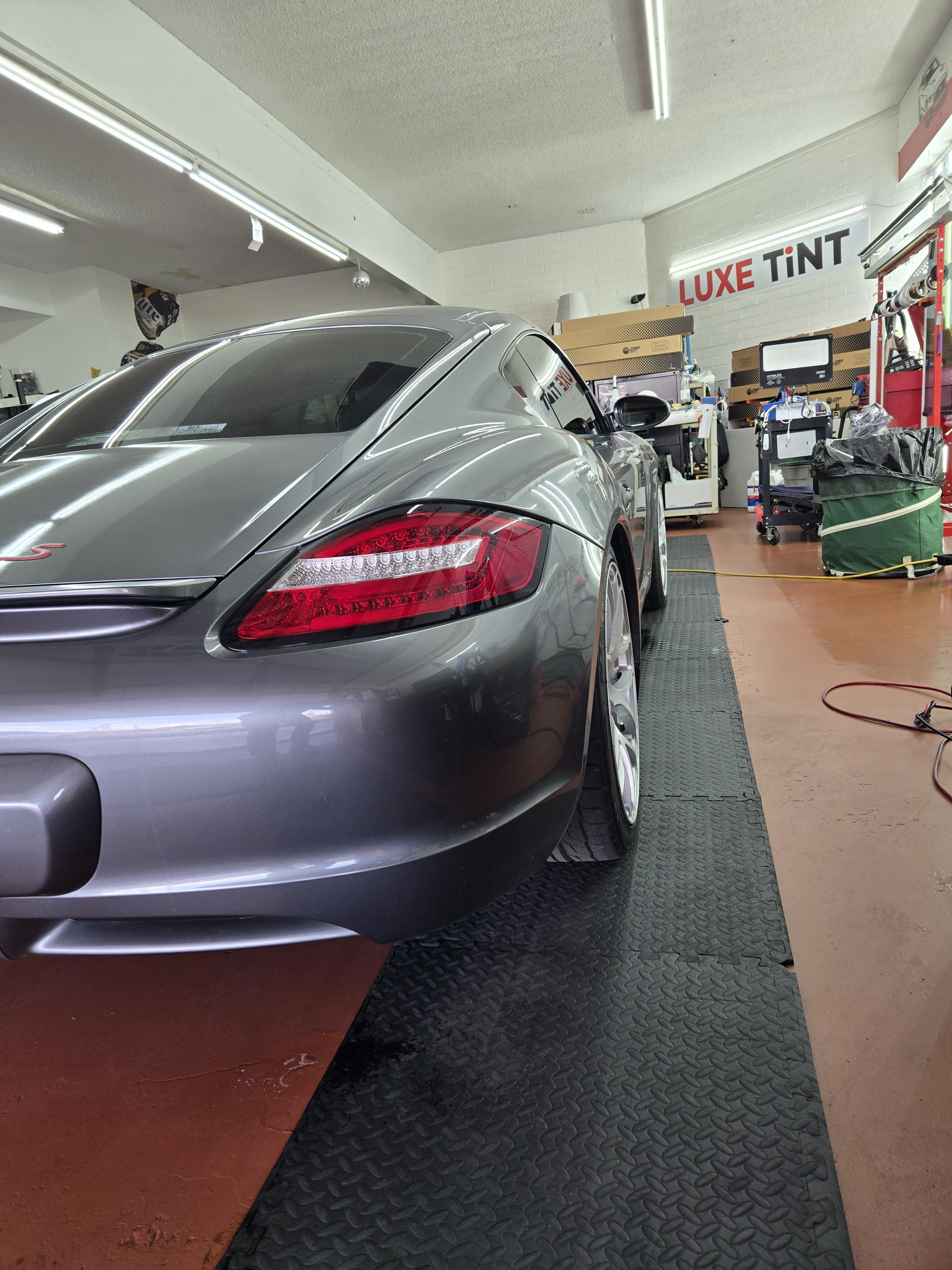 Grey Porsche Cayman, rear three-quarter