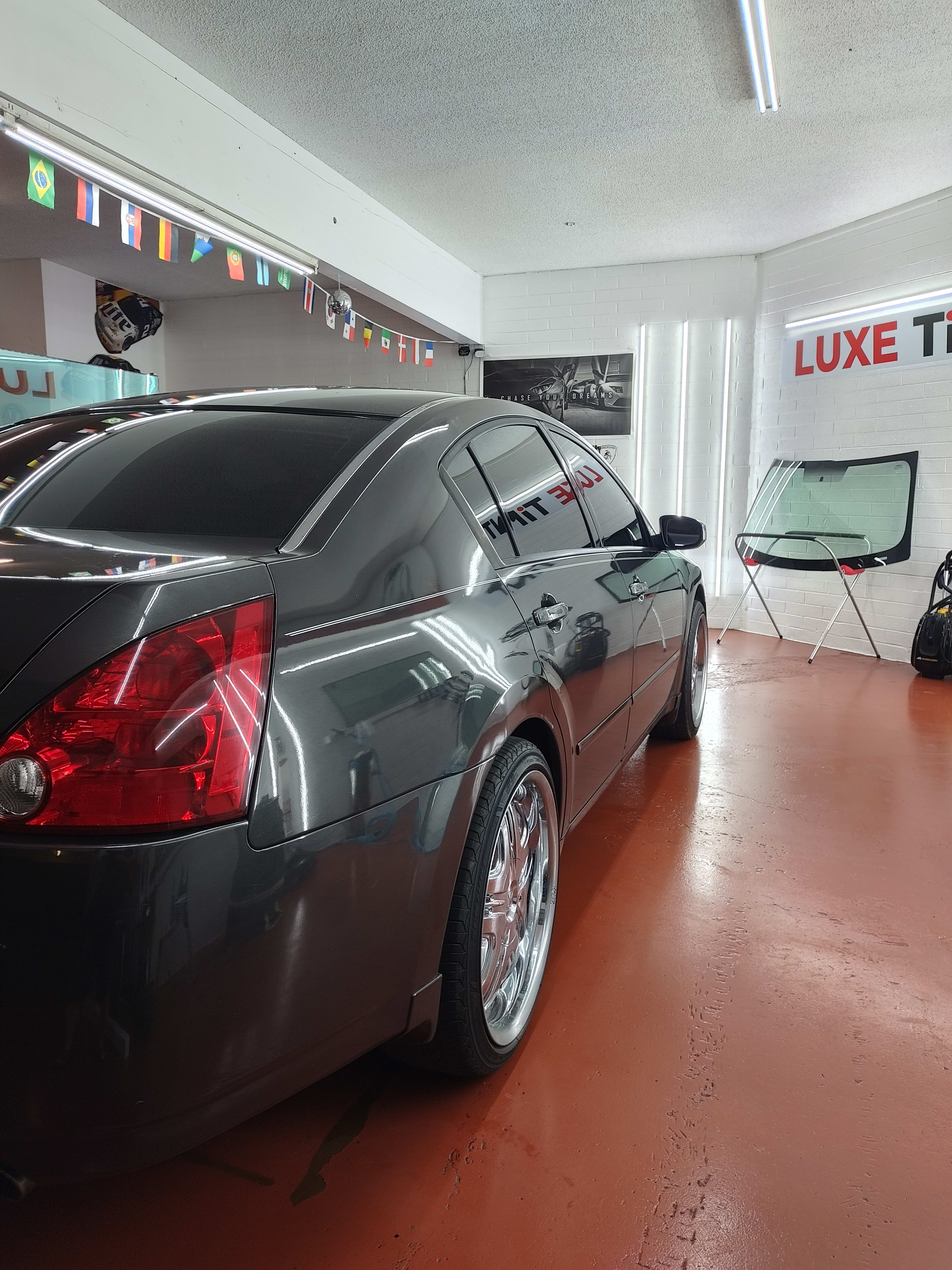 Grey Nissan Maxima, rear three-quarter