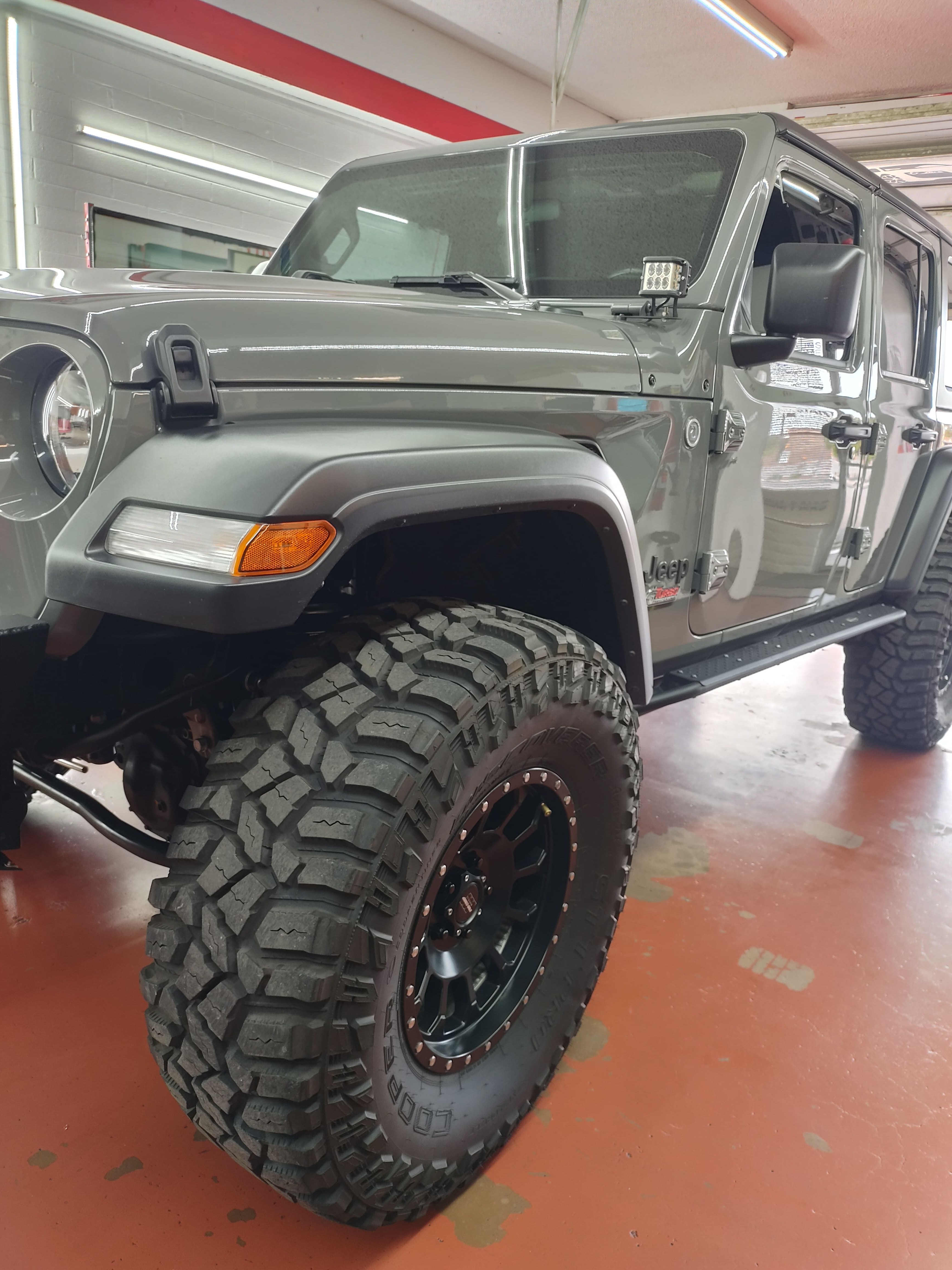 Grey Jeep Wrangler, side with spare tire