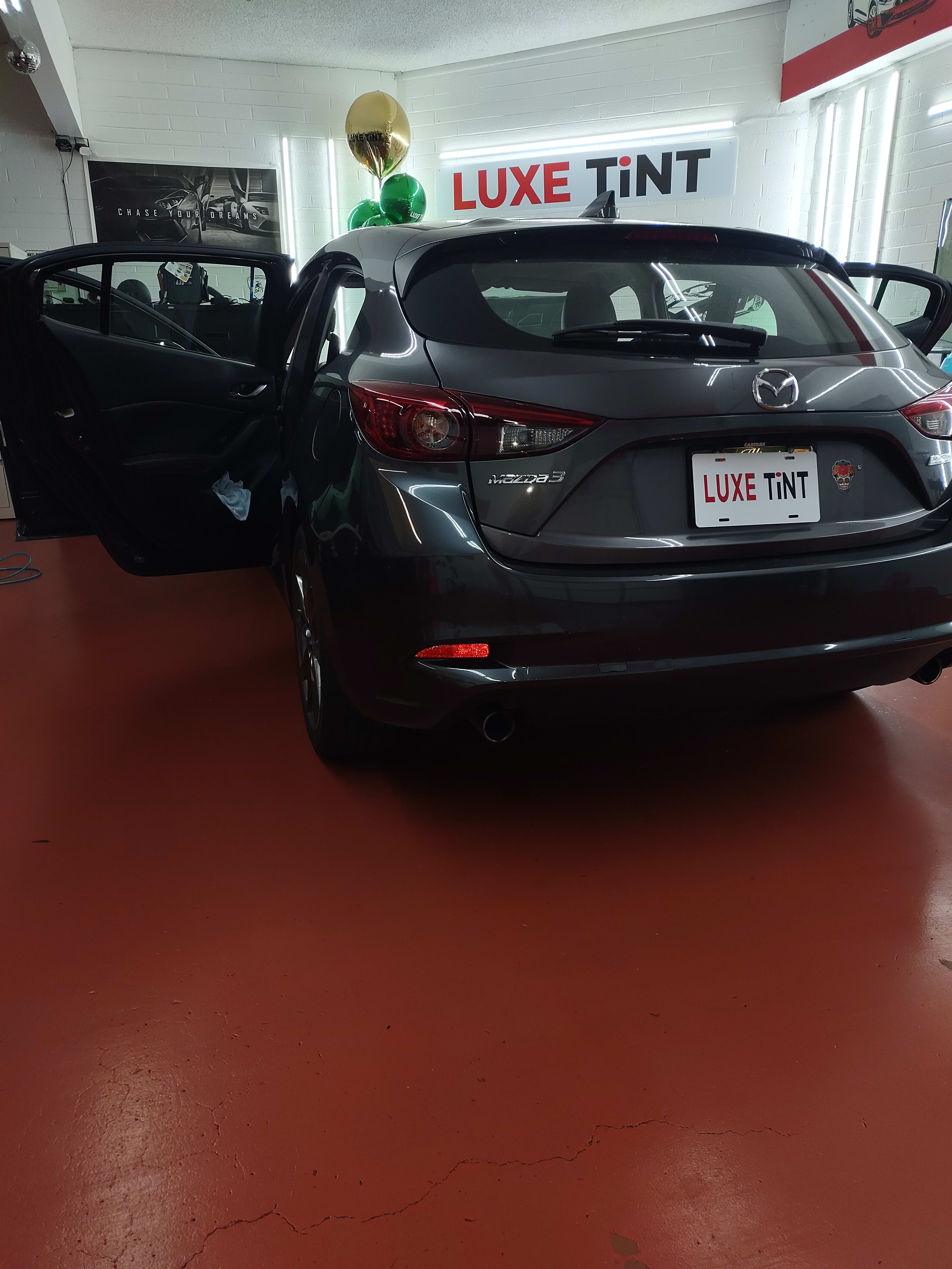 Grey Mazda3 hatchback, rear