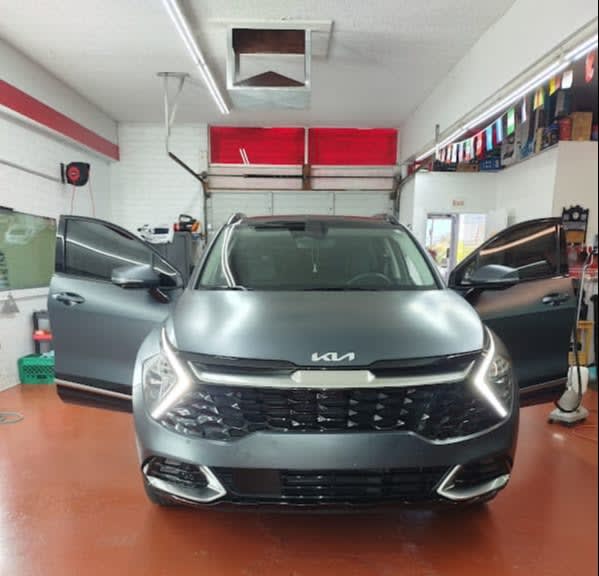 Grey Kia Sportage, front with doors open