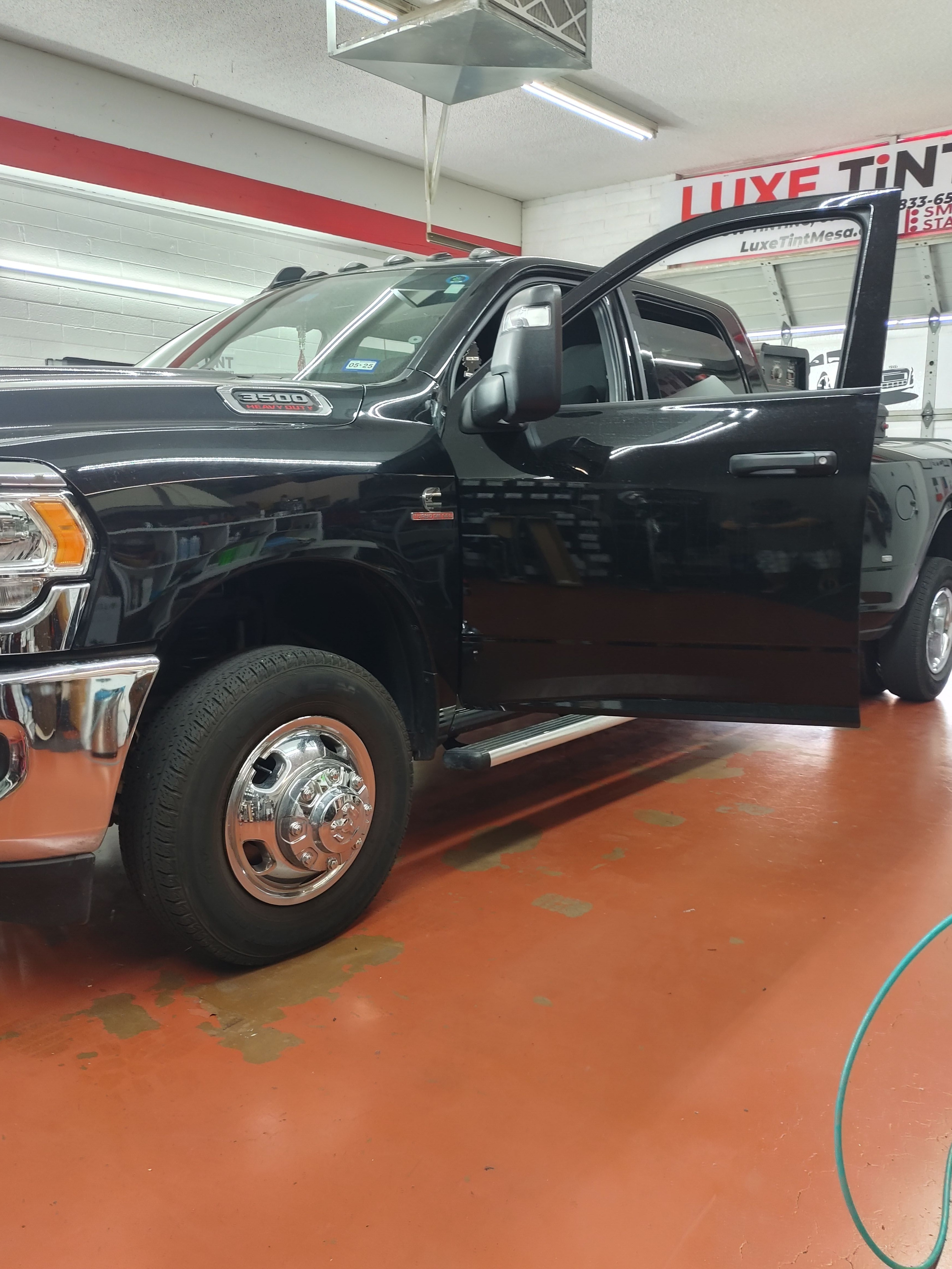 Black Ford F-350, side with door open