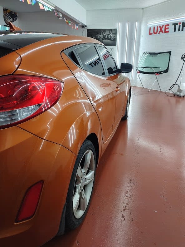 Orange Hyundai Veloster, rear three-quarter