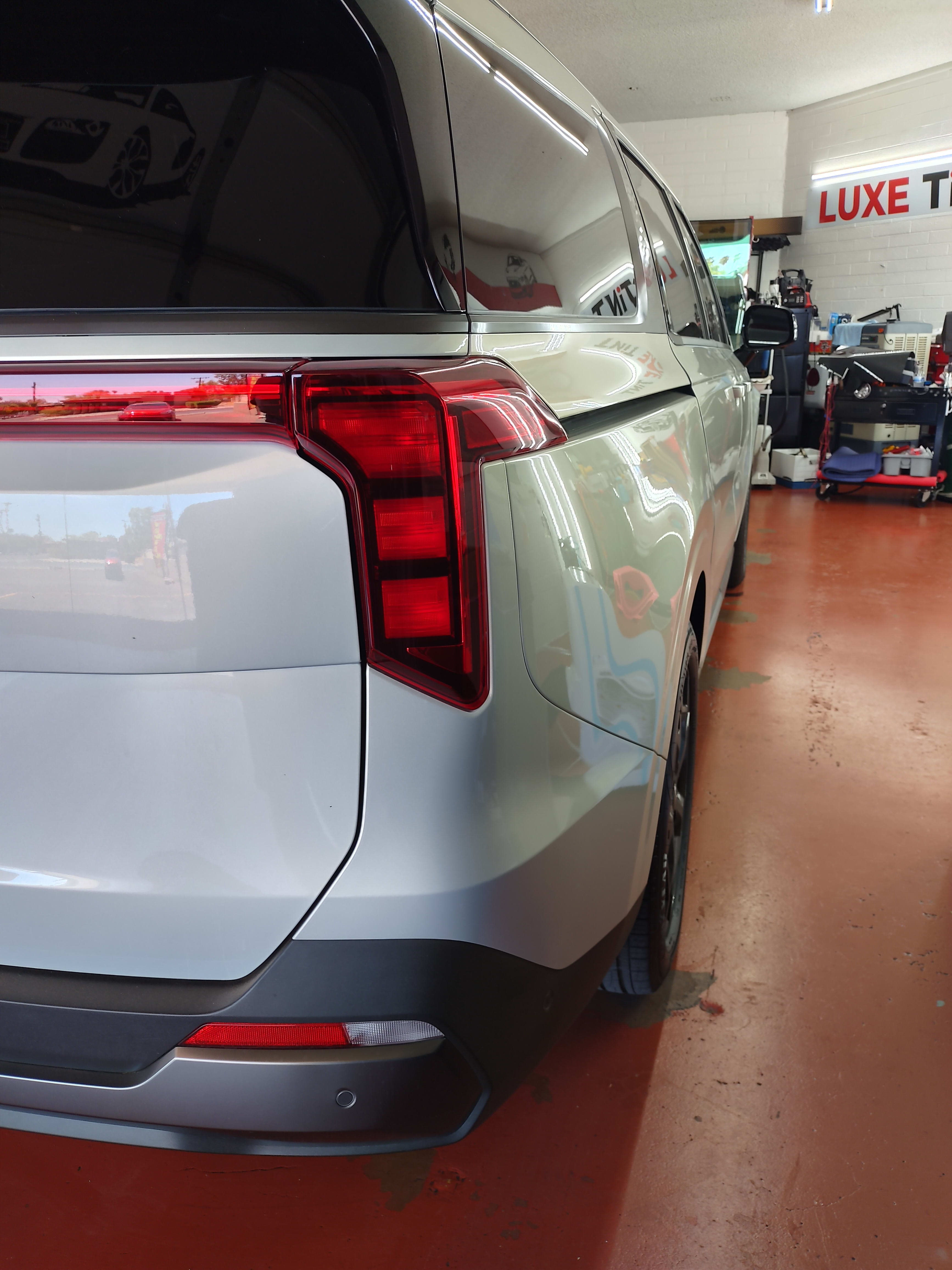 Silver Kia SUV, rear