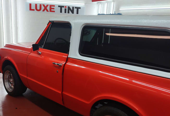 Orange and white Chevy C10, side