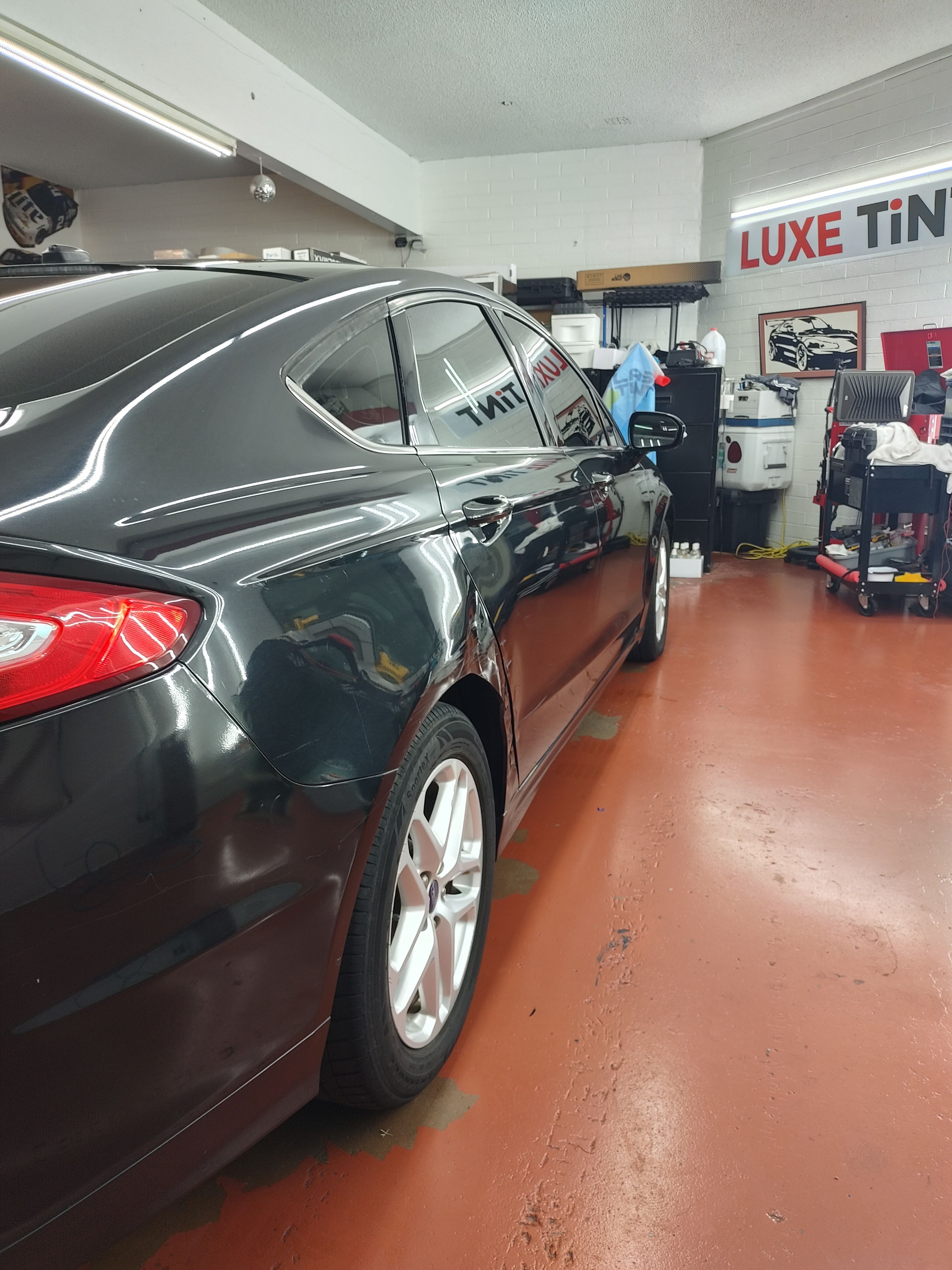 Grey Ford Fusion, side with white wheels