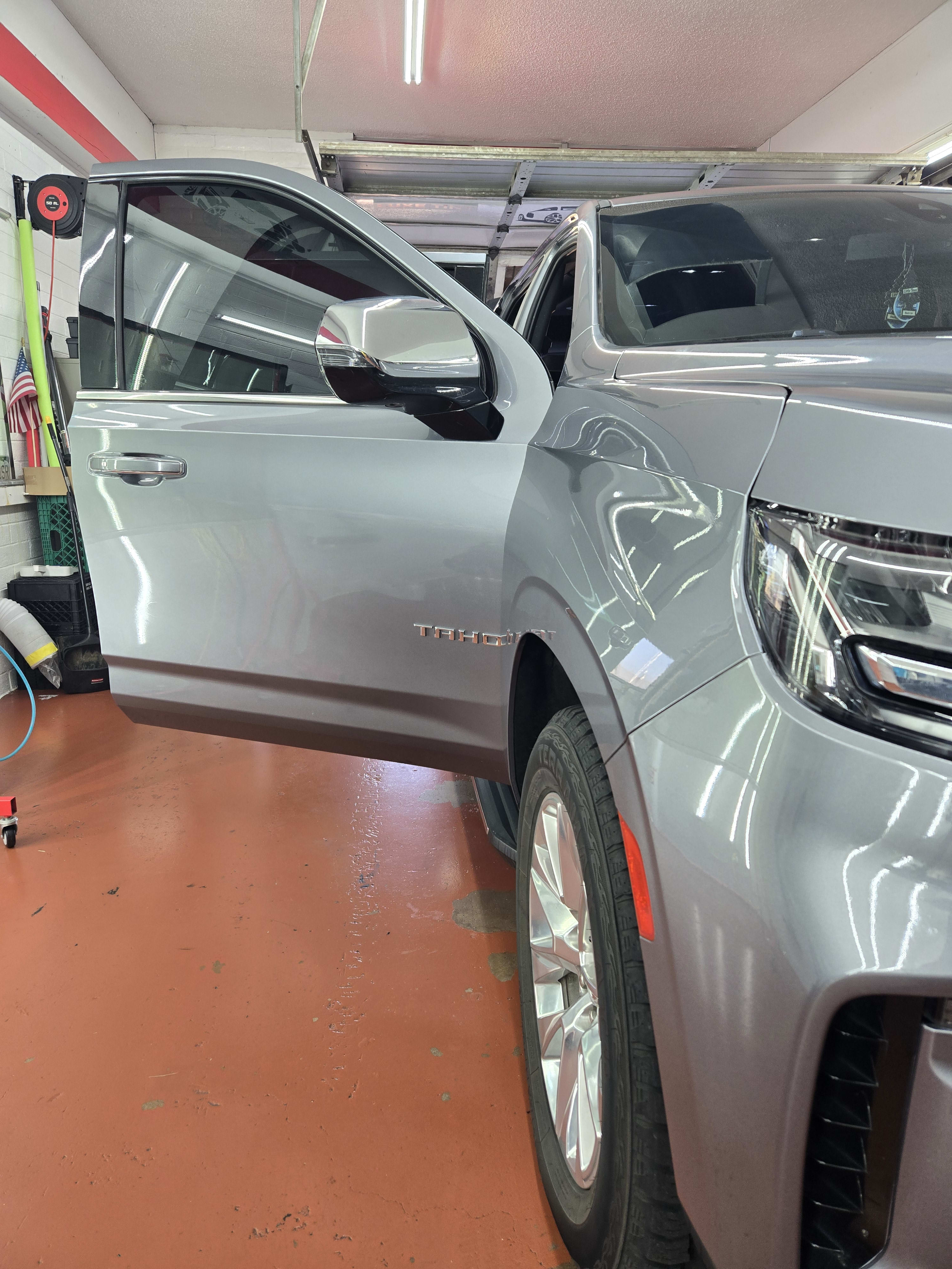 Silver Chevy Tahoe, door open