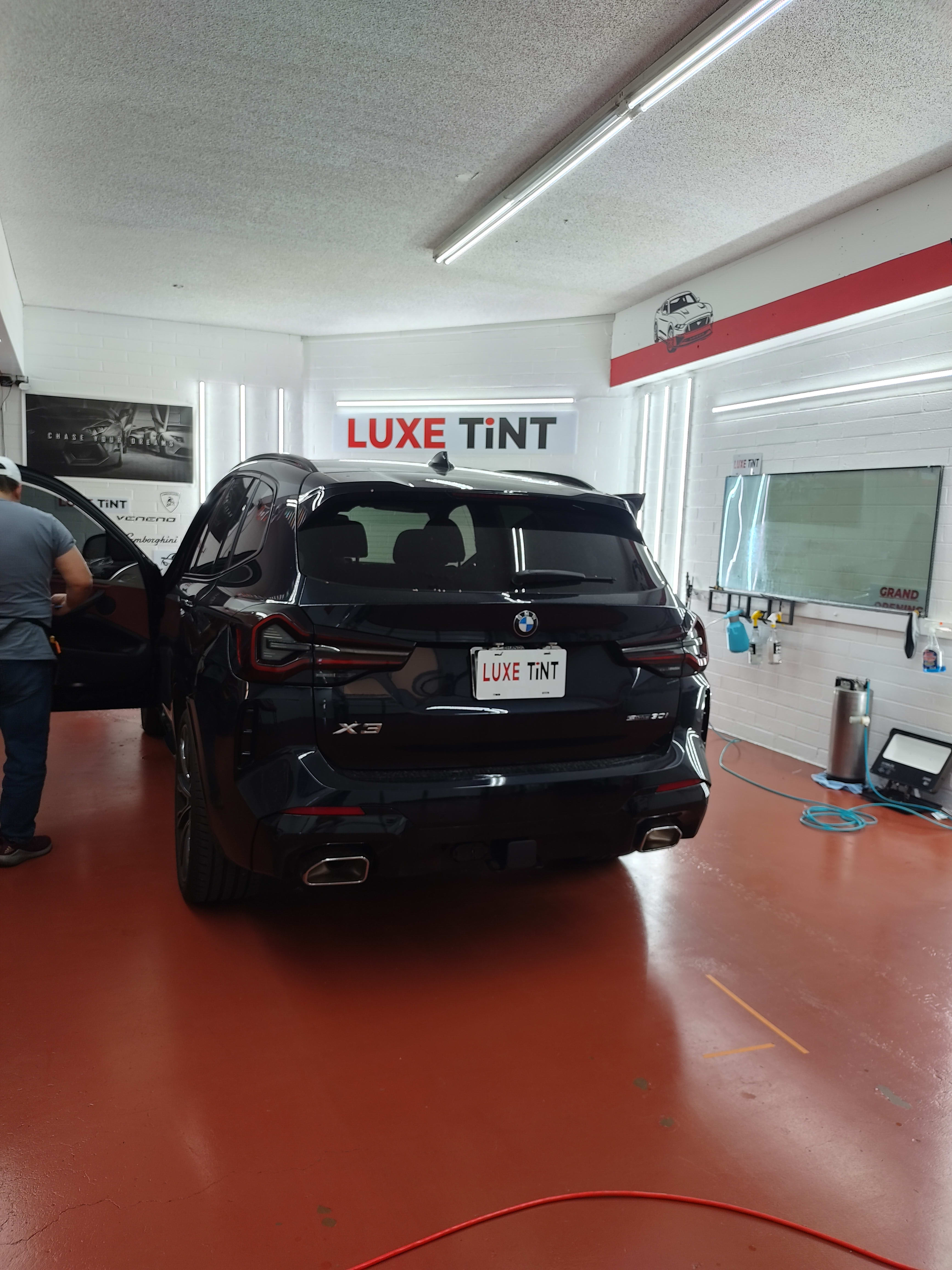 Black BMW X3, rear with Luxe Tint plate