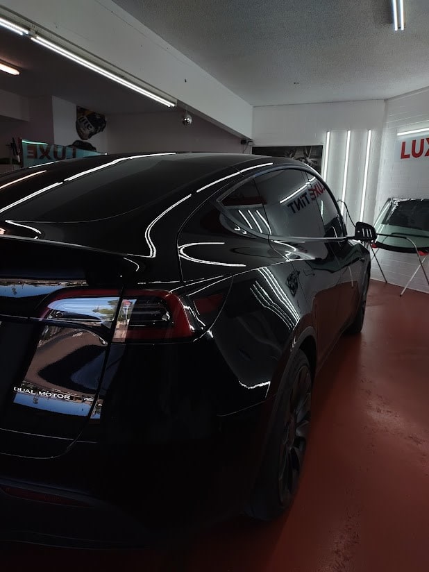 Black Tesla Model 3, rear three-quarter