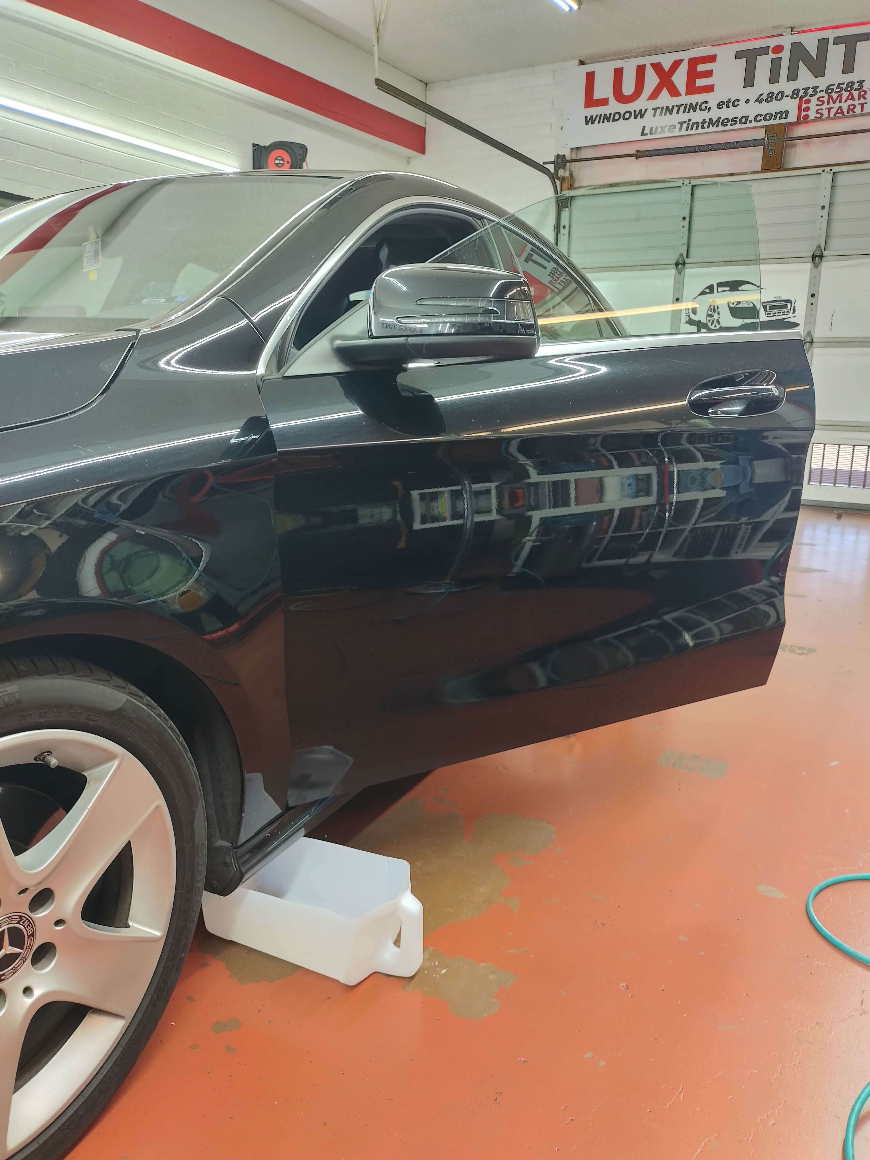 Black Mercedes 4MATIC sedan, front door