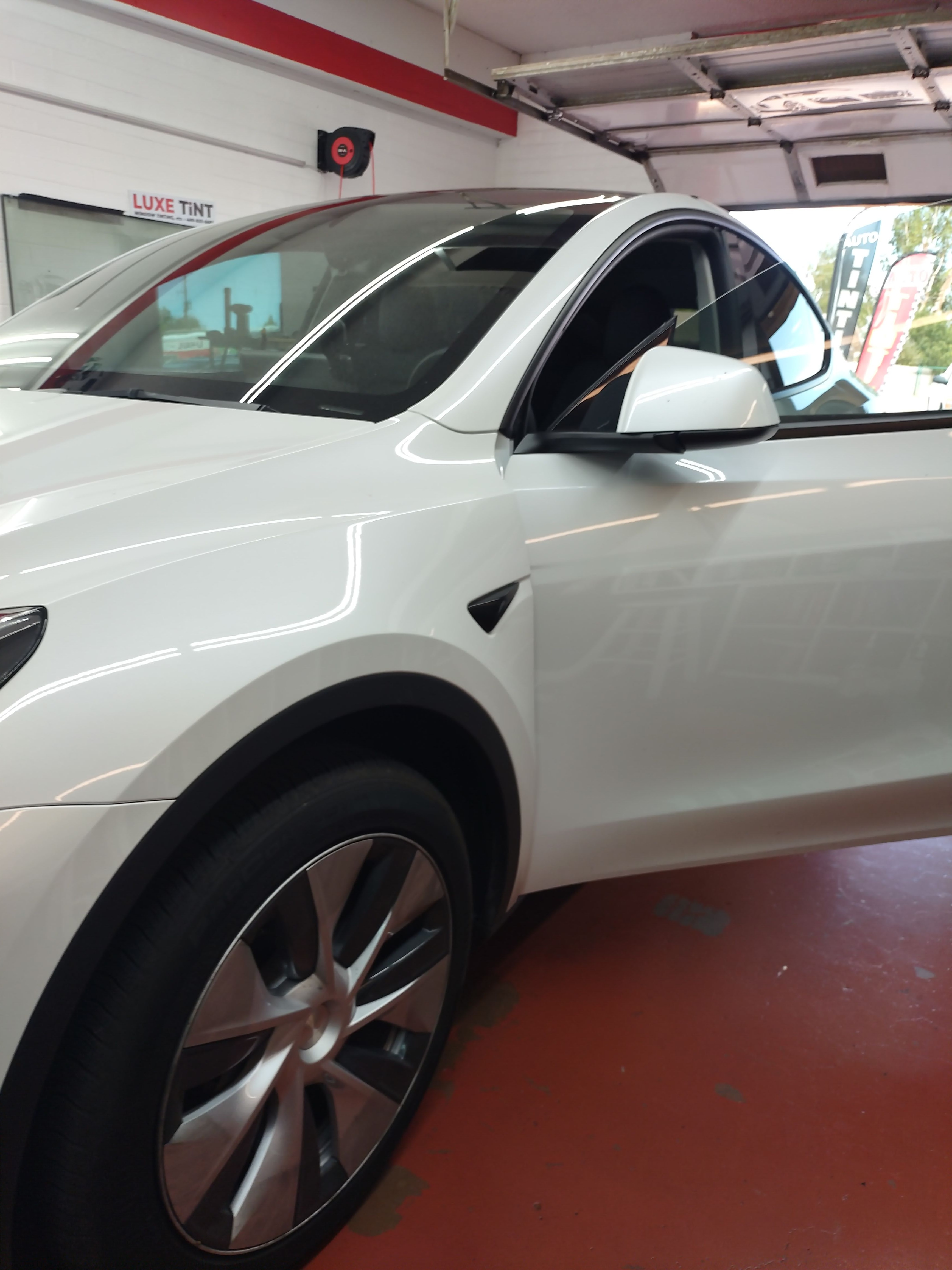 White Tesla Model 3, side with door open