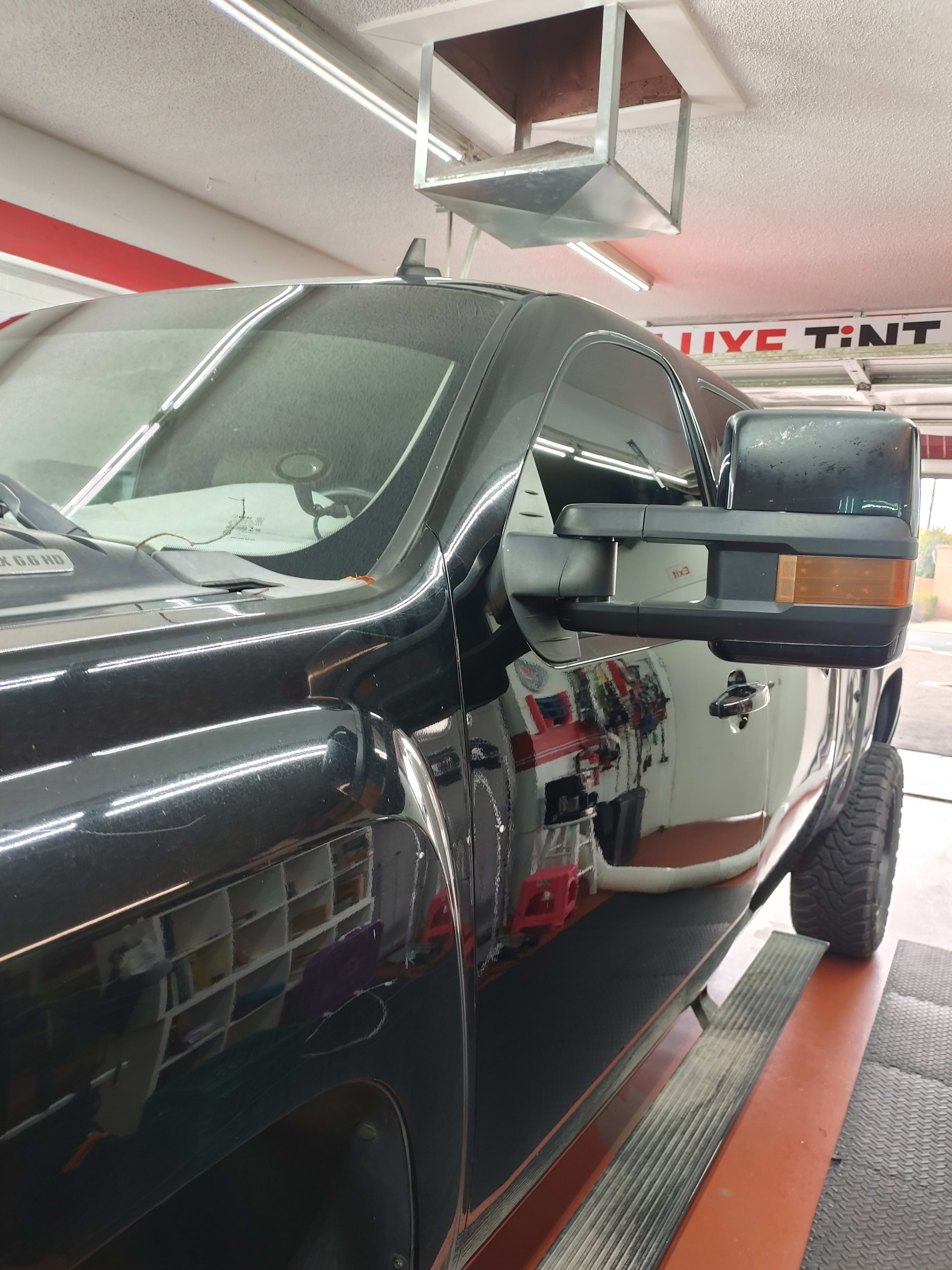 Black Chevy Silverado 2500HD, front, shop sign