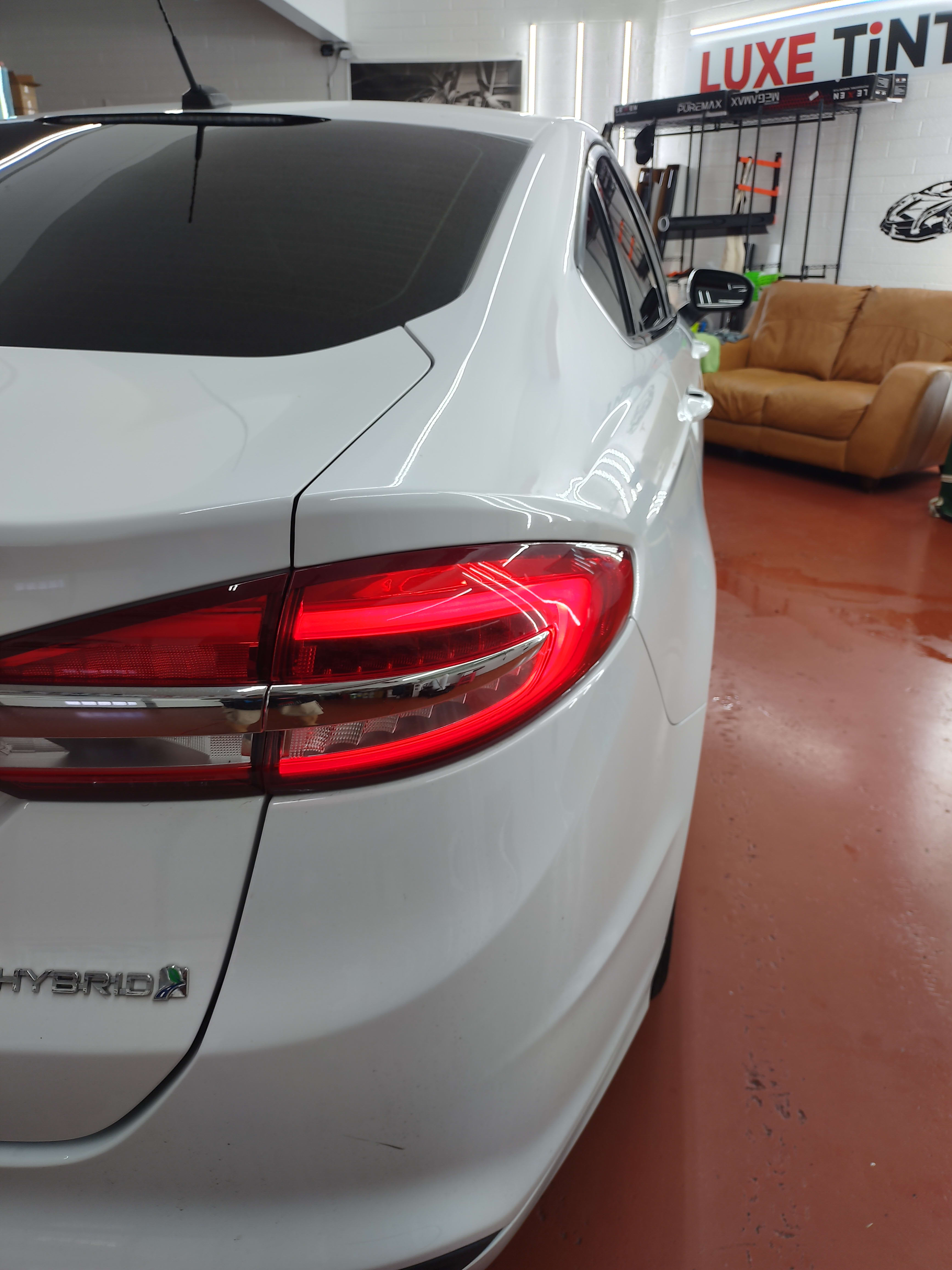 White Ford Fusion Hybrid, rear