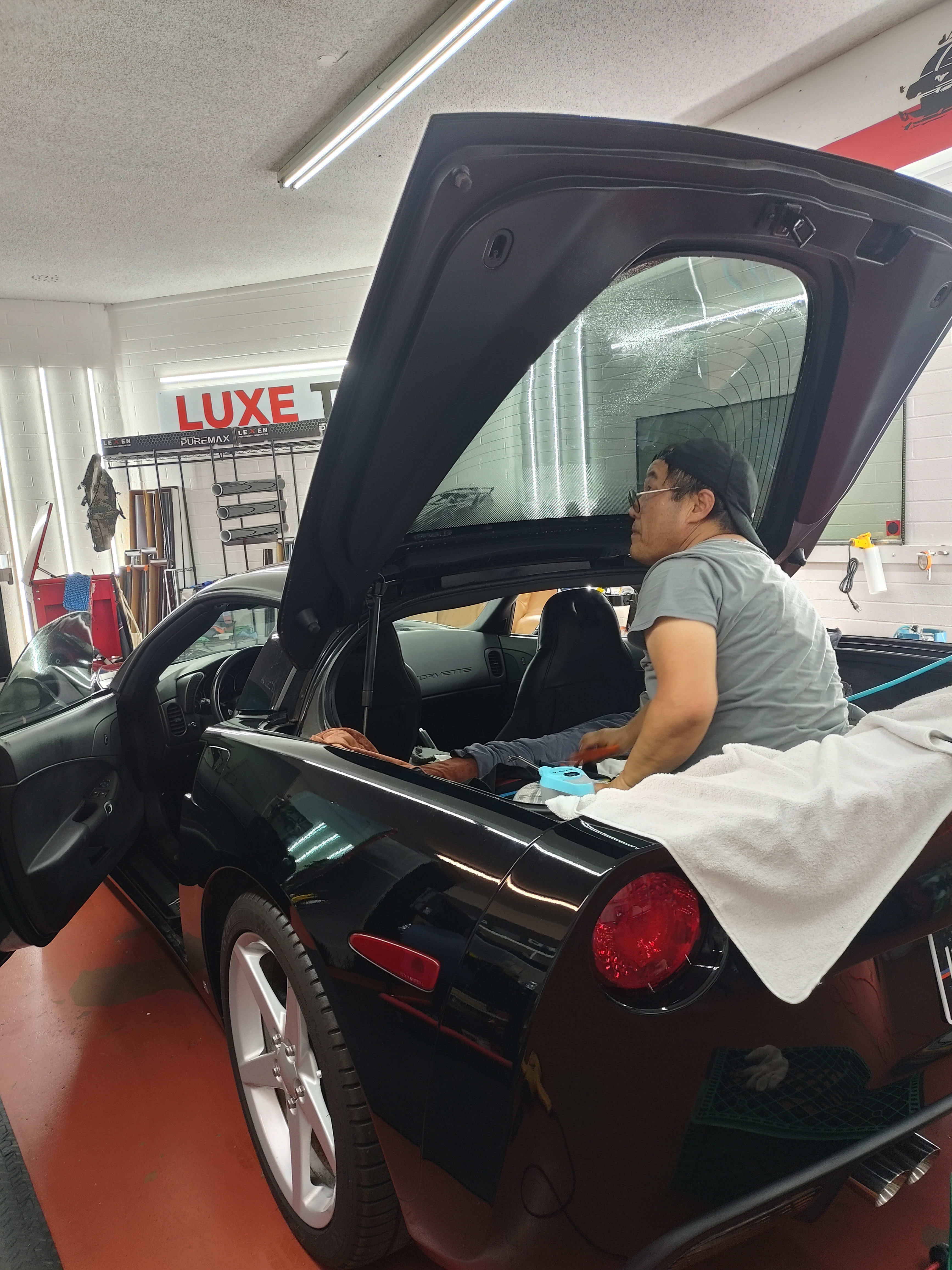 Black Chevy Corvette, rear glass install