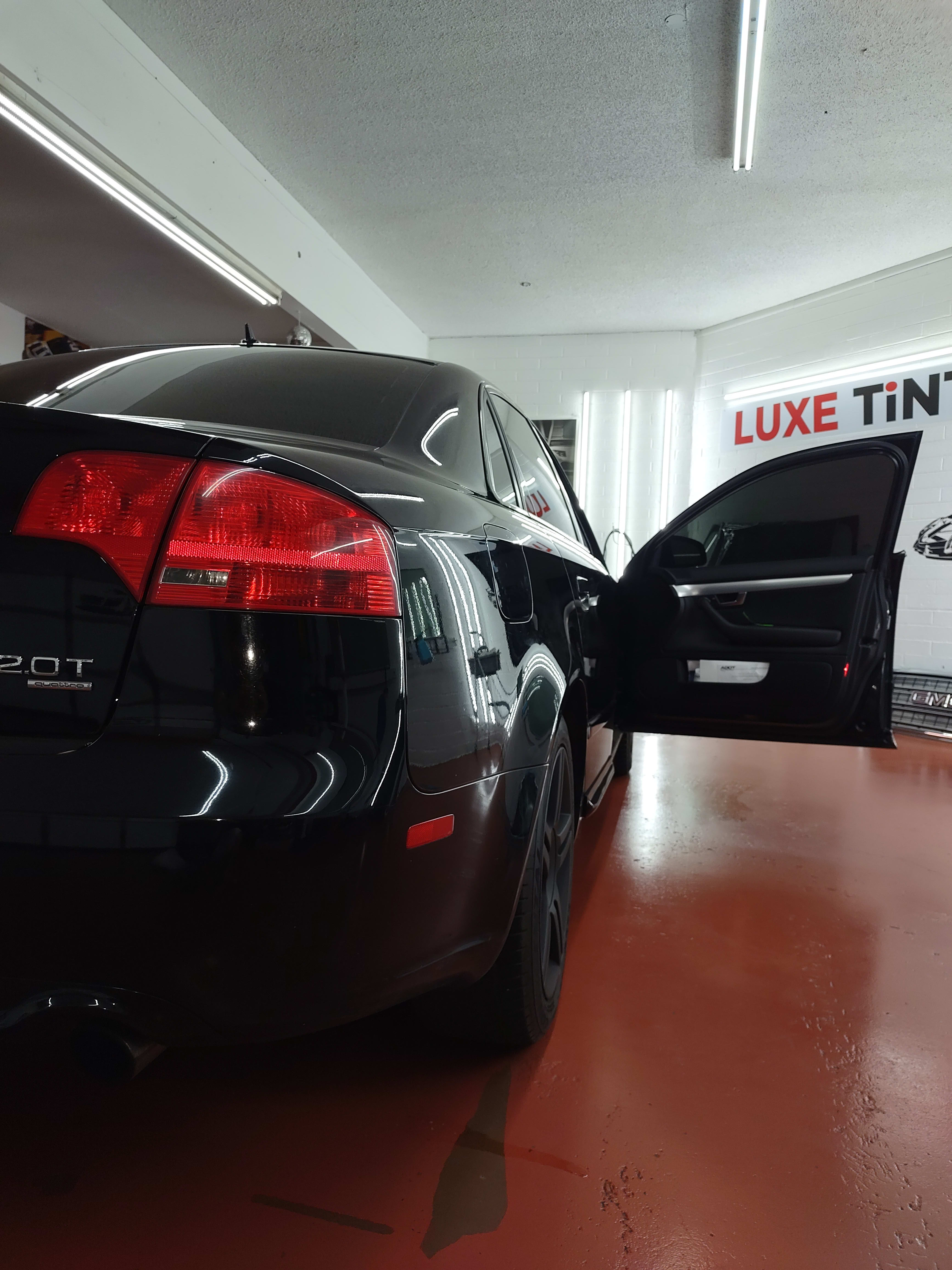 Black Audi A4, rear three-quarter