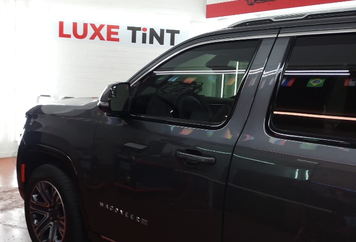 Black Jeep Wagoneer, side glass