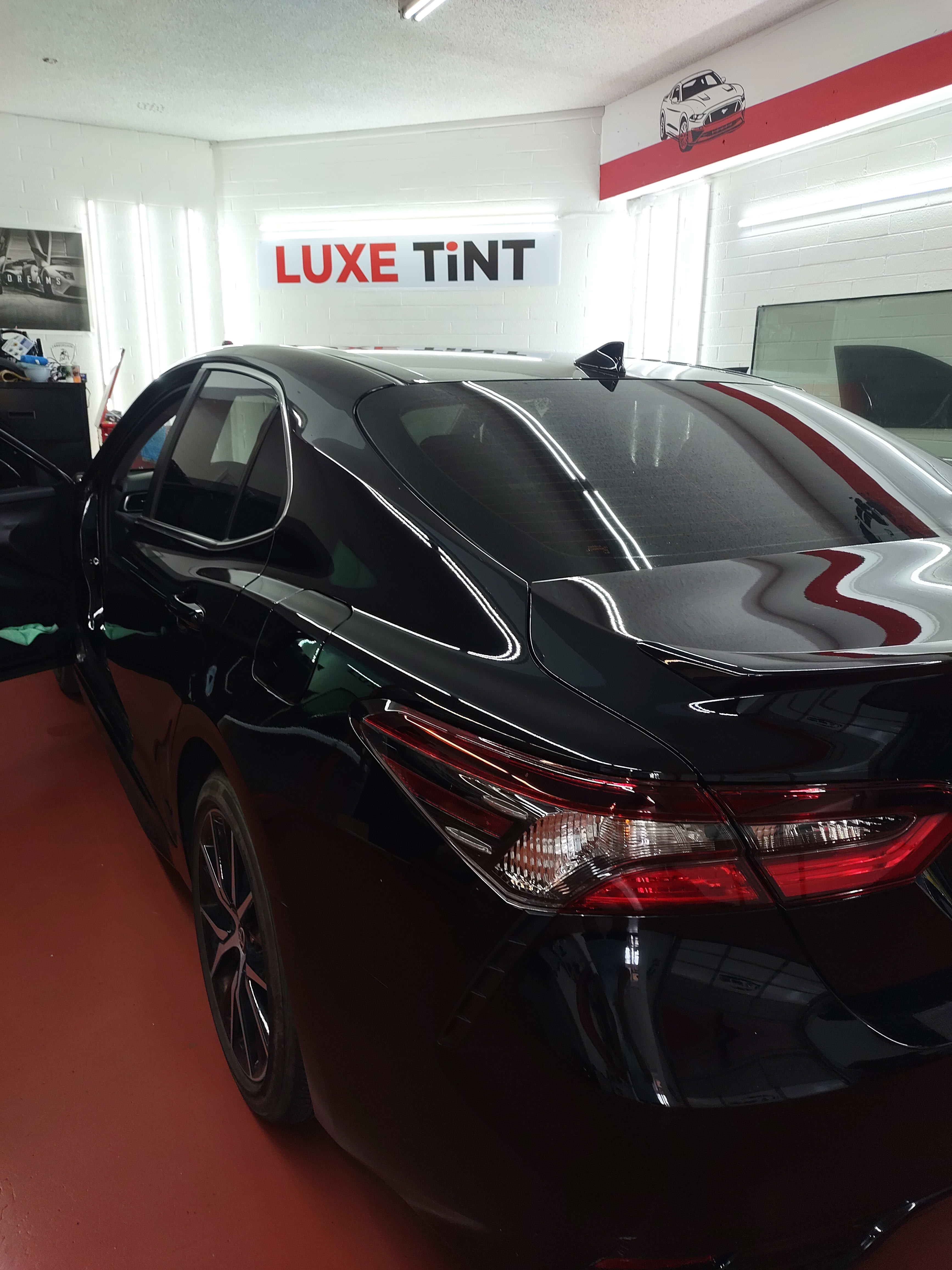 Black Toyota Camry, rear three-quarter