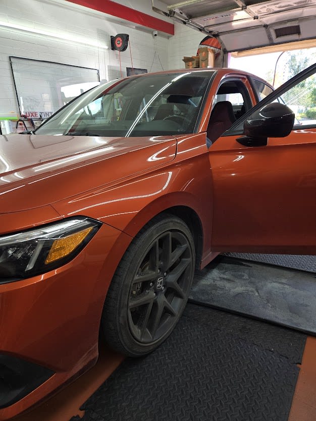 Orange BMW 3 Series, front three-quarter