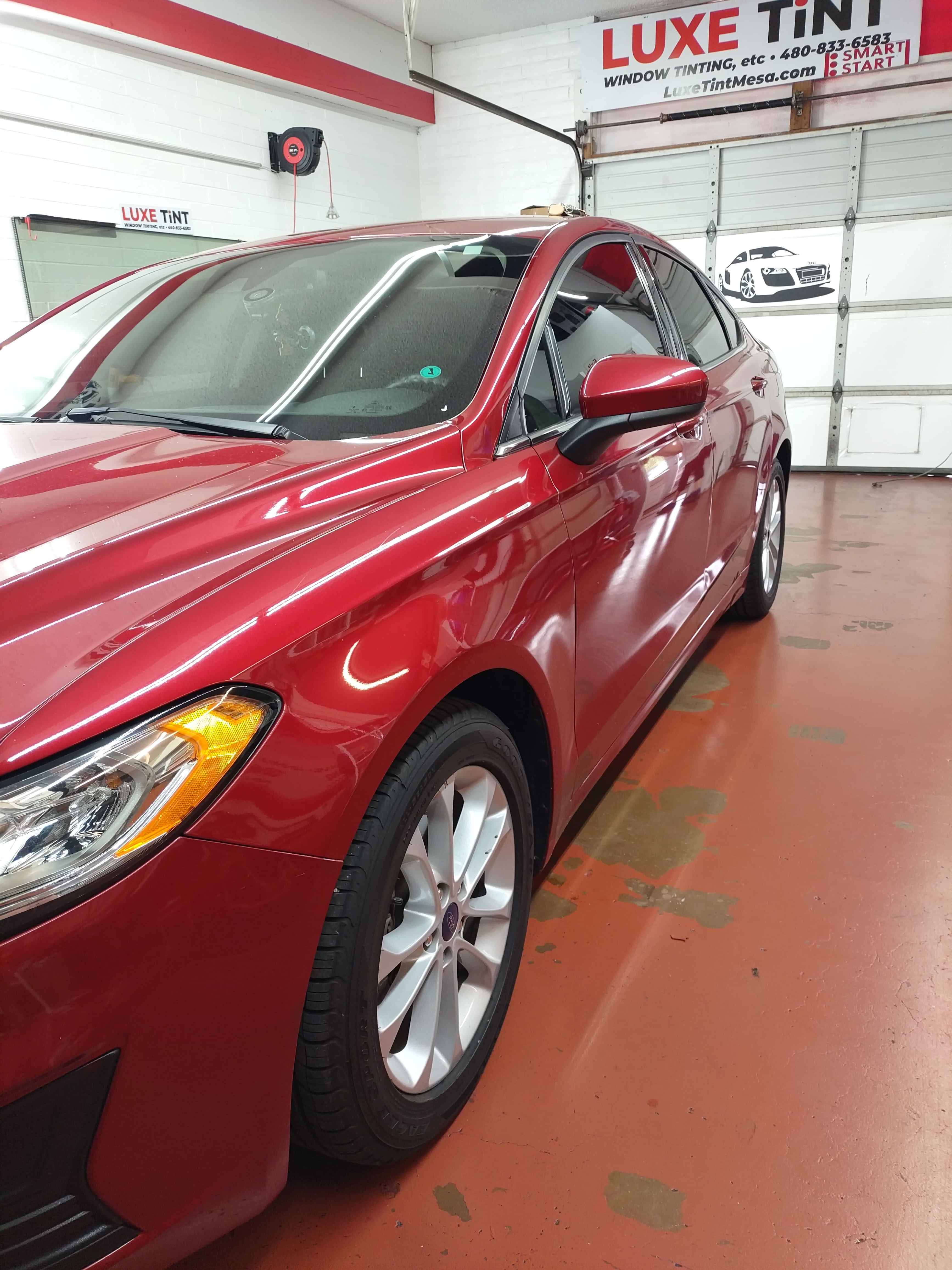 Red sedan, front three-quarter