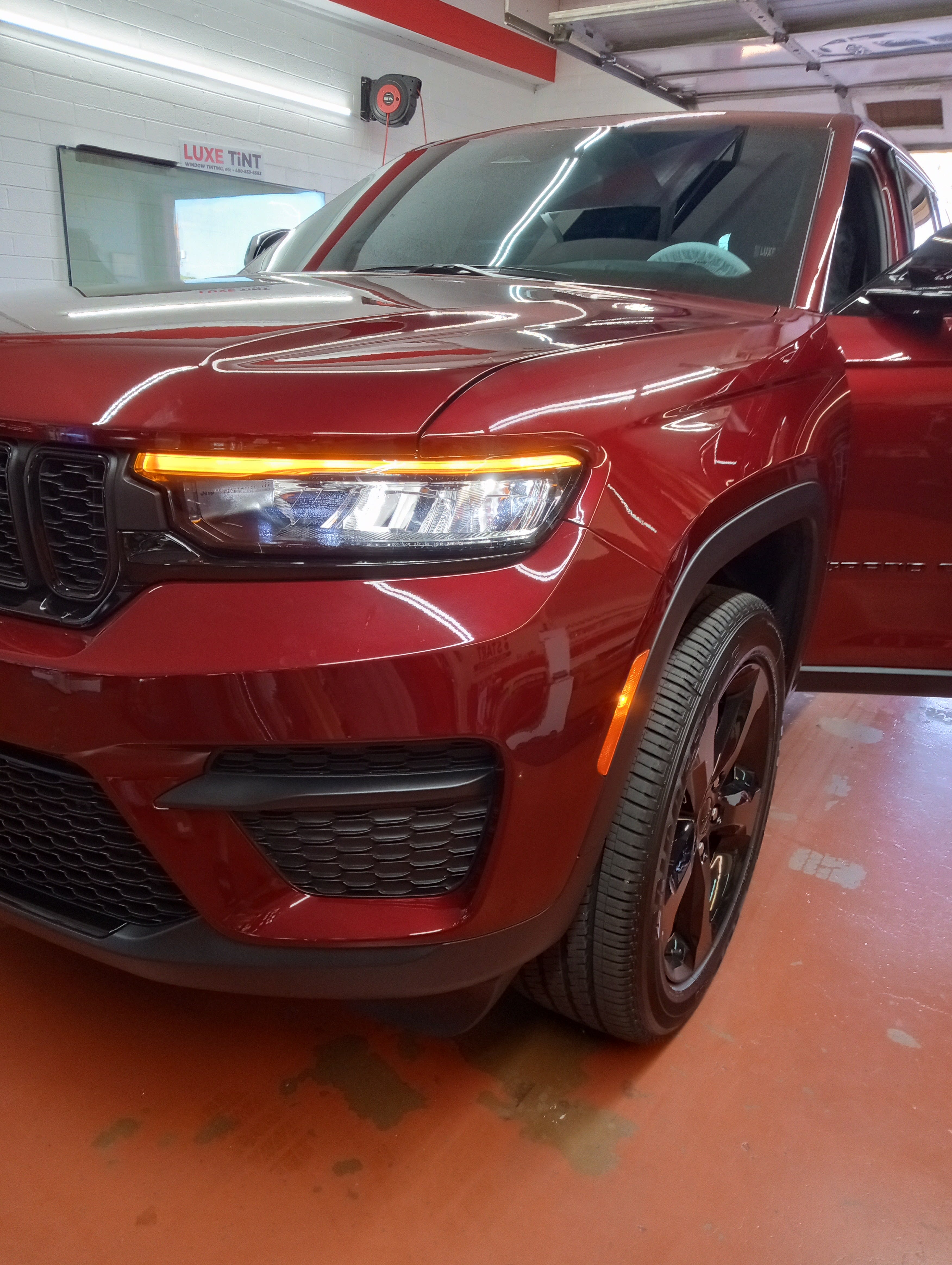 Red Jeep Grand Cherokee, front three-quarter