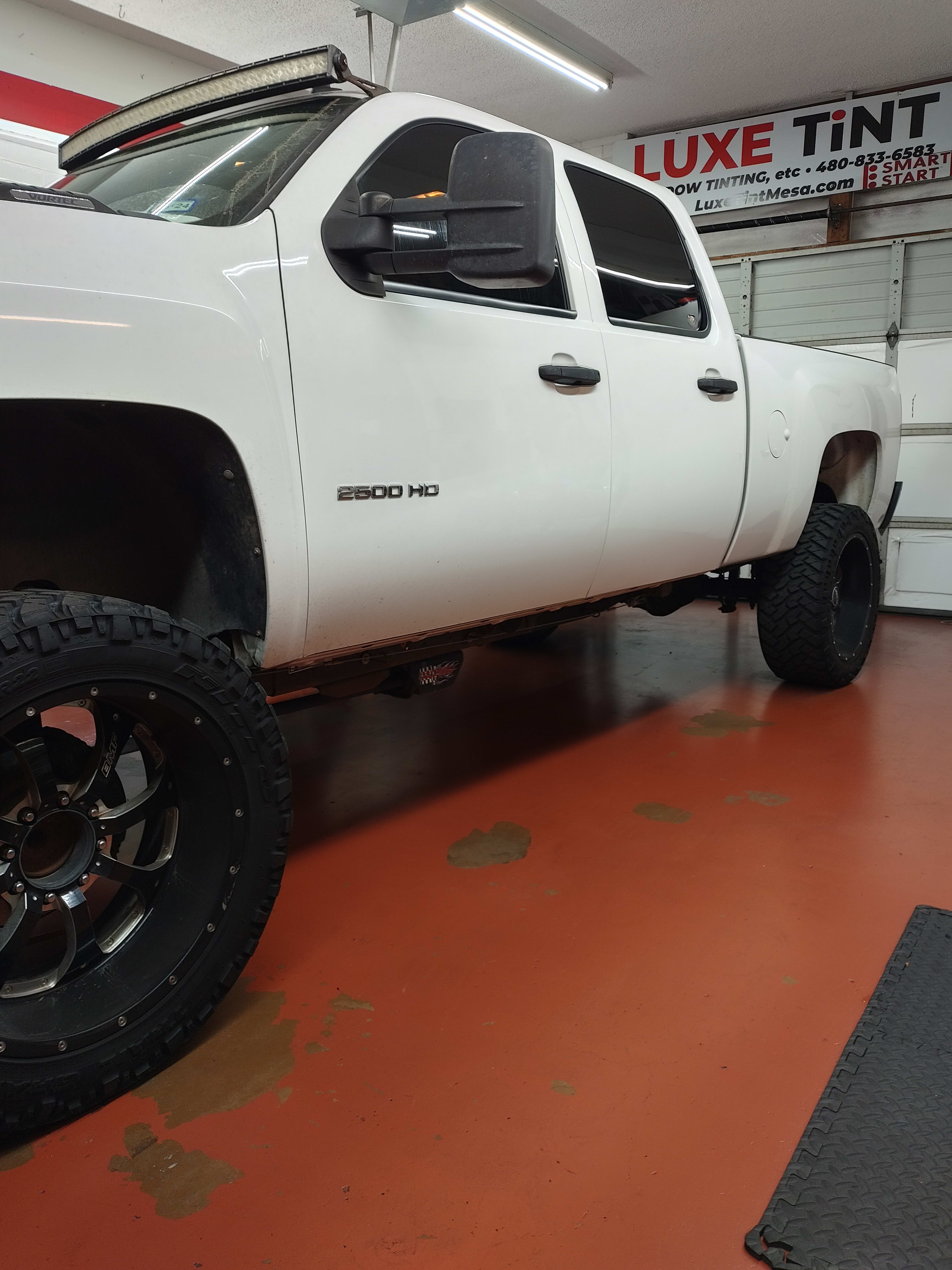 White Chevy Silverado 2500HD lifted, side