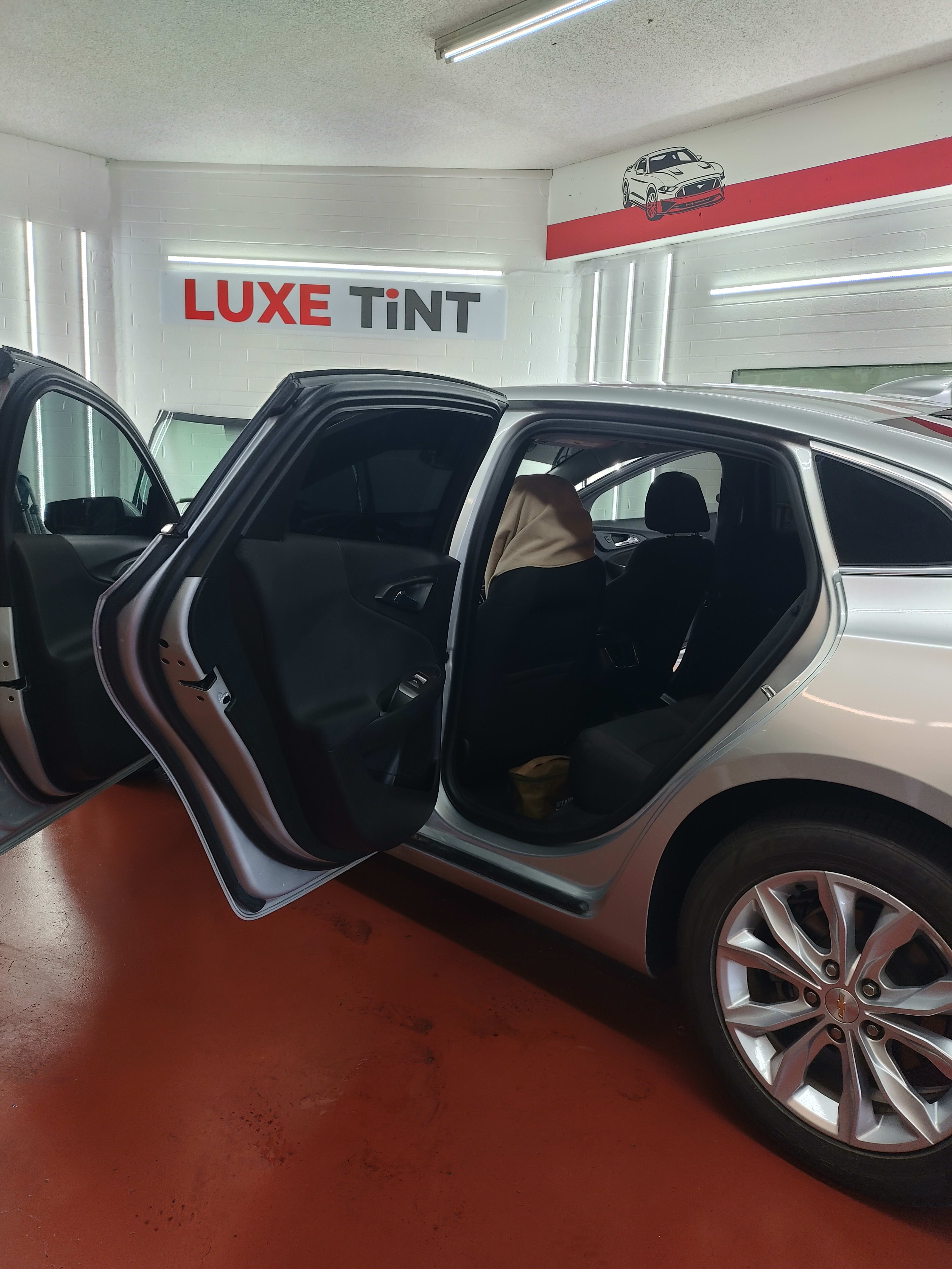 Silver Chevy Malibu, rear doors open