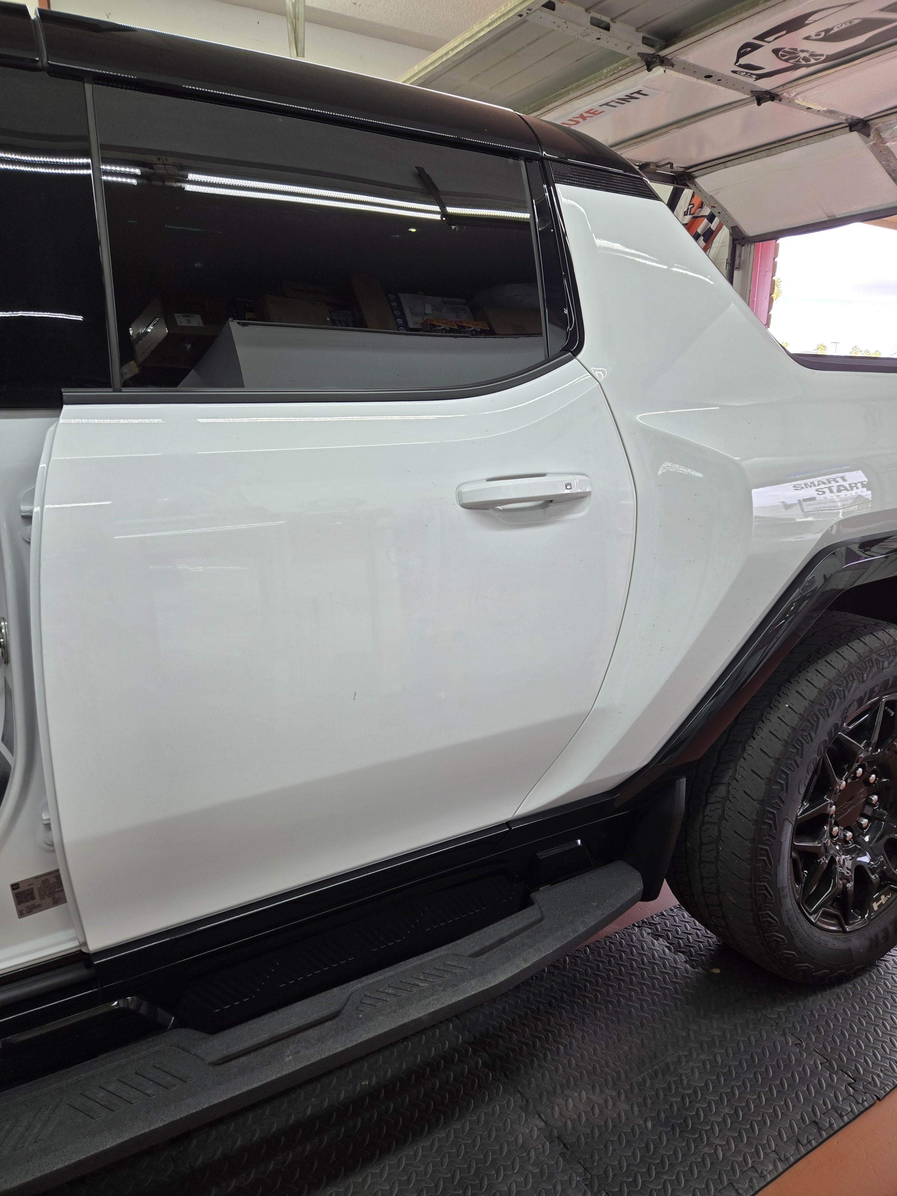 White GMC Hummer EV, side glass