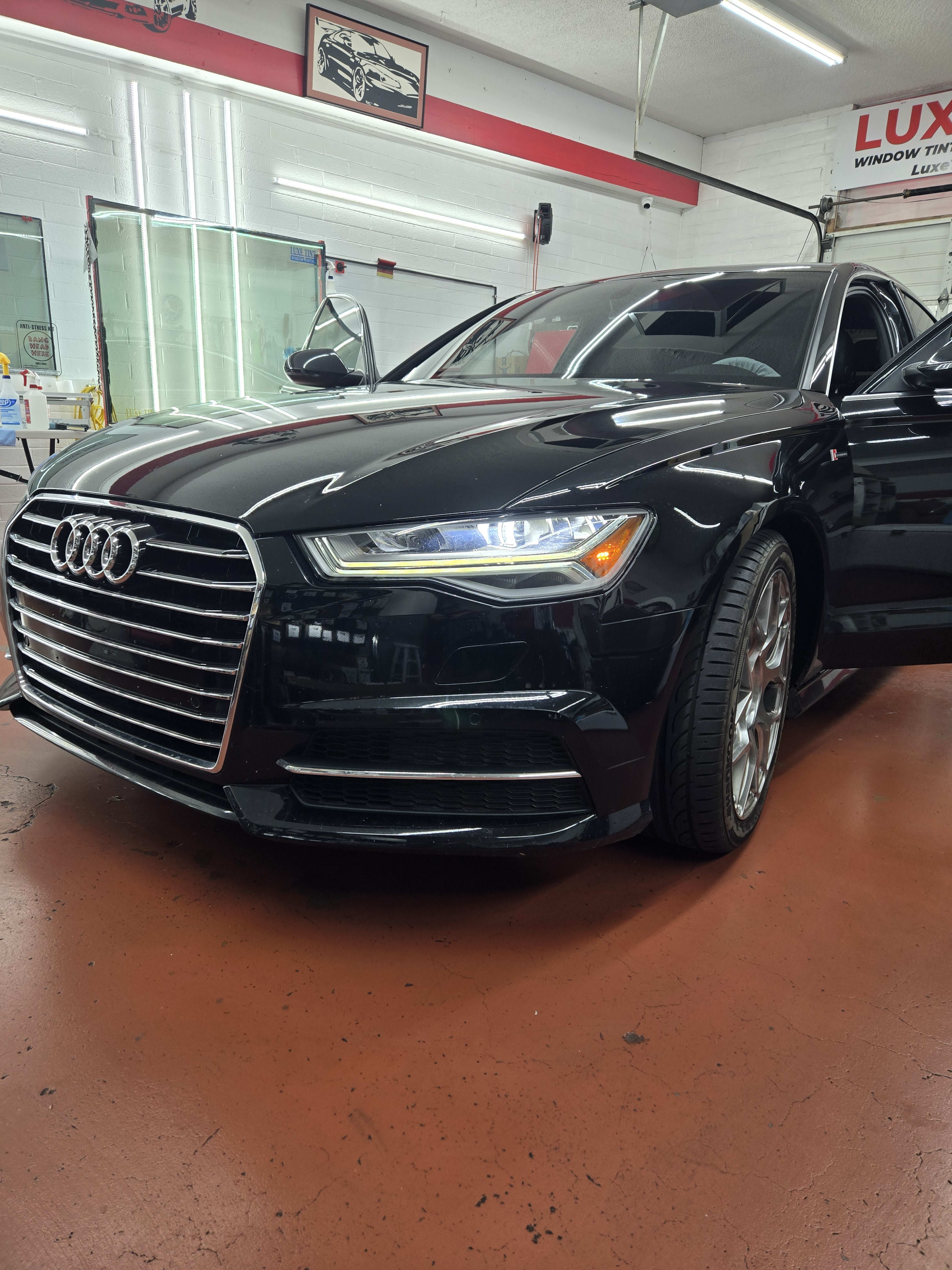 Black Audi A6, front three-quarter