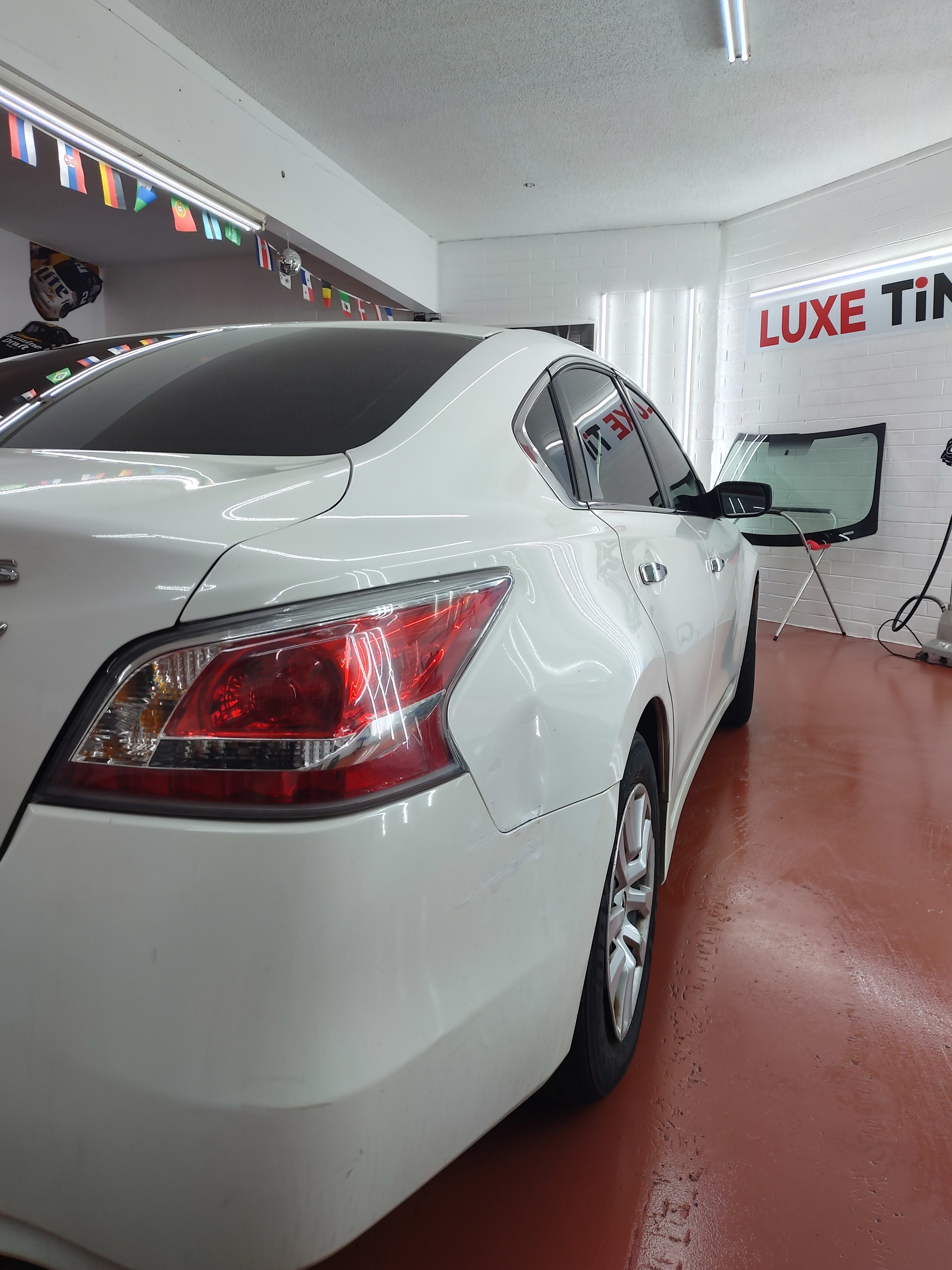 White Nissan Altima, rear three-quarter
