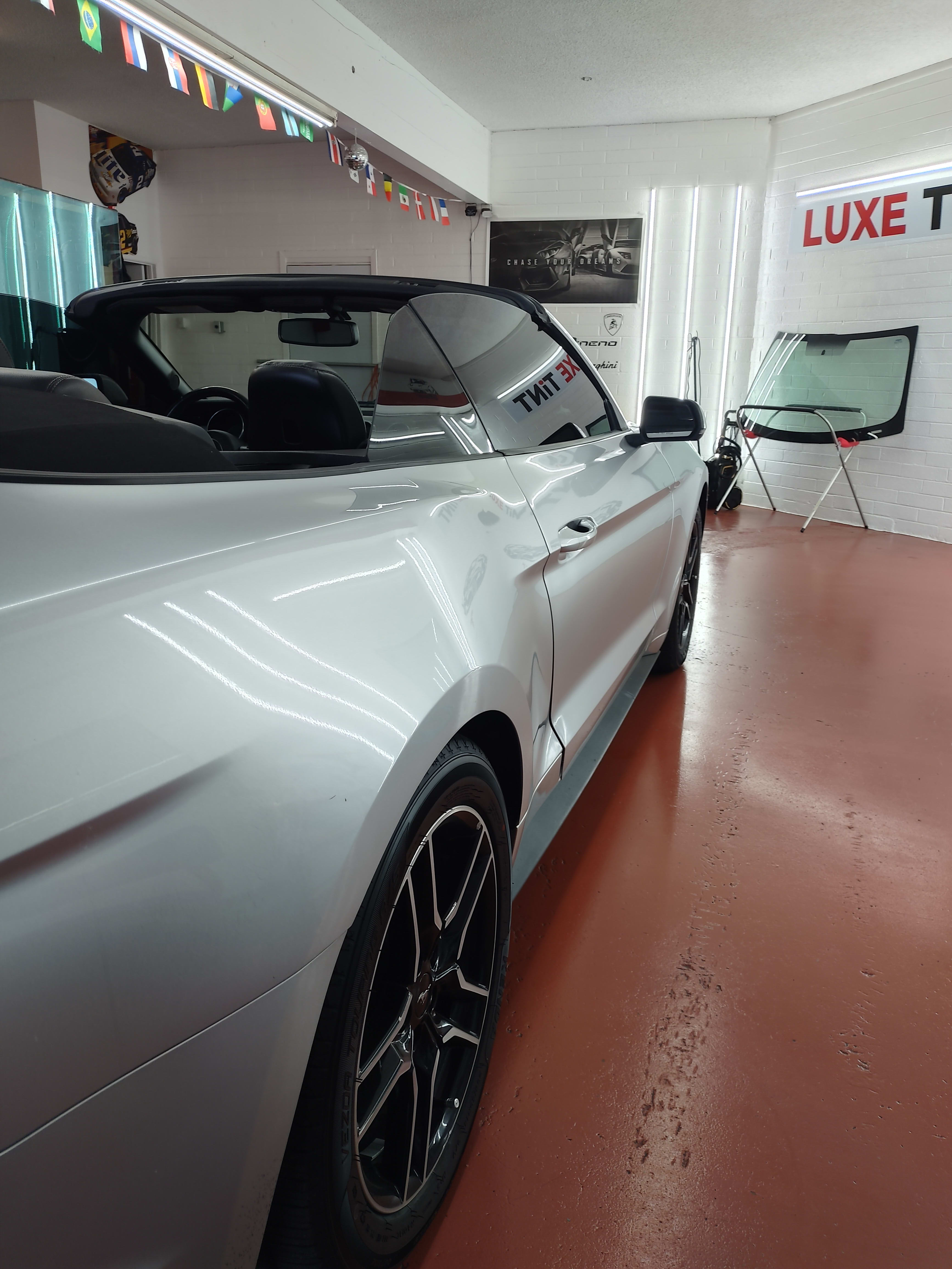 Silver Ford Mustang convertible, rear three-quarter